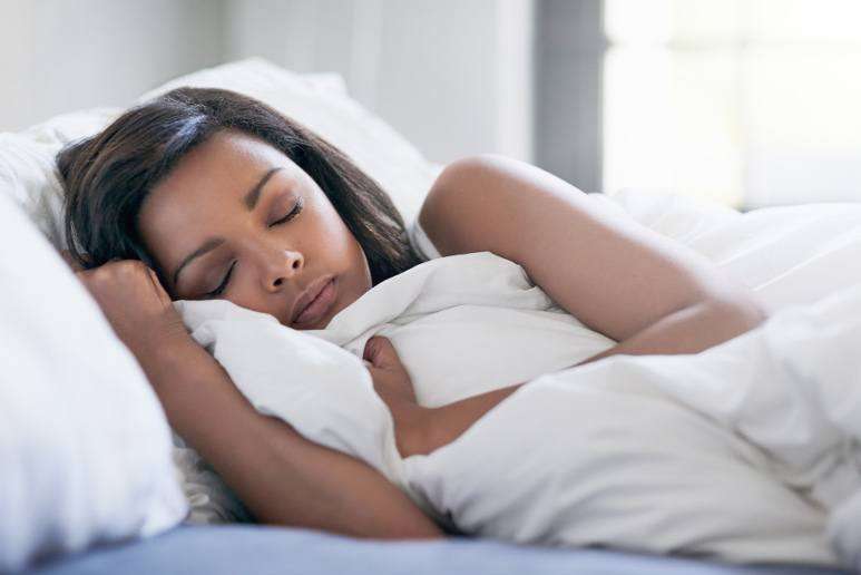 Woman sleeping on her replacement mattress