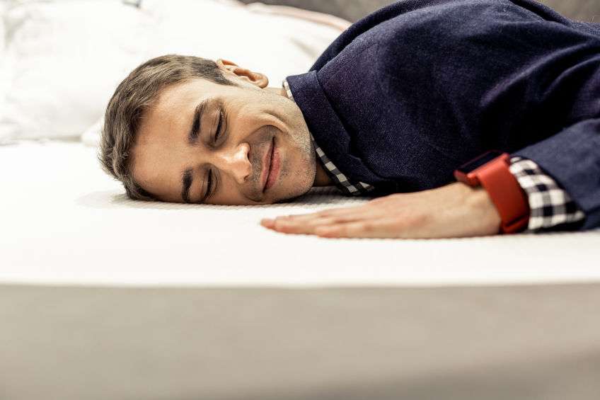 Man Sleeping Happily on Comfortable Mattress