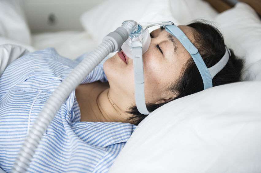 Woman Sleeping Peacefully in CPAP Mask