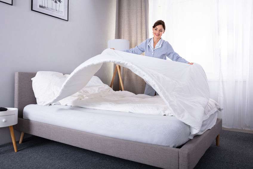 Woman changing her bedding and getting her mattress ready for spring.