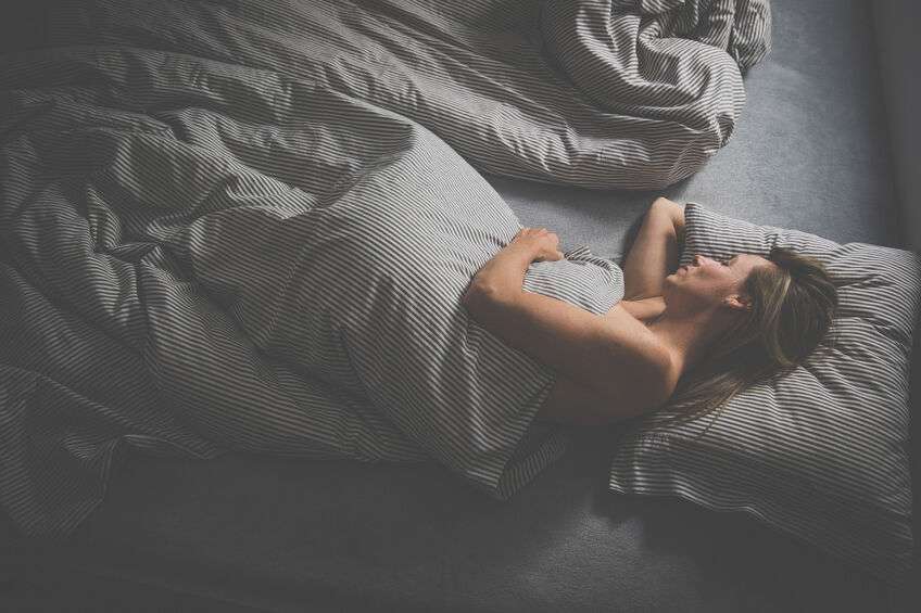 Middle-aged woman sleeping in her bed at home, having a good night’s sleep