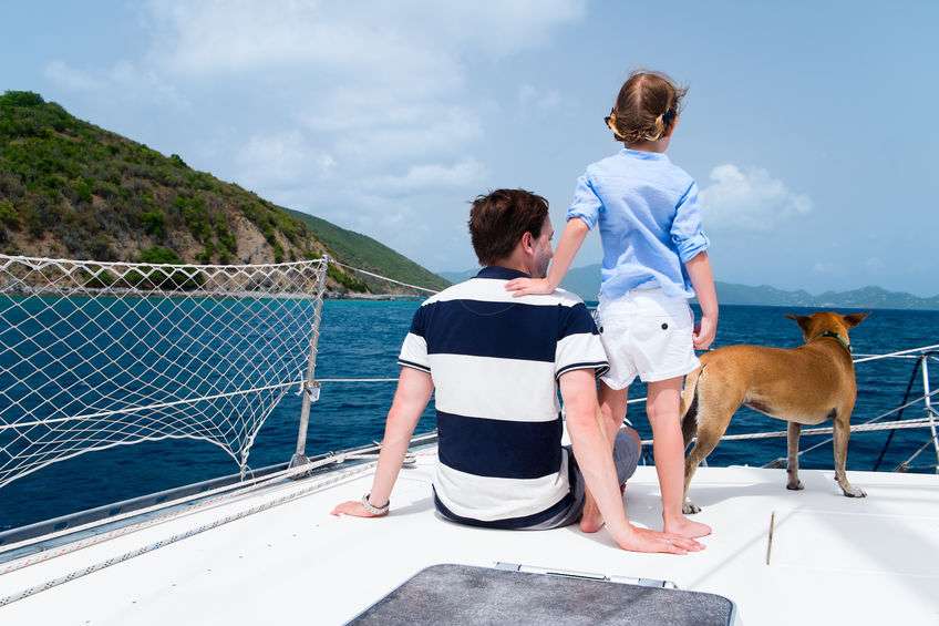 Father, daughter and their pet dog on boat that they live on full-time