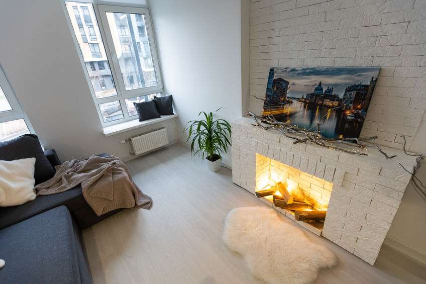 Small studio apartment interior with kitchen area and rope screen